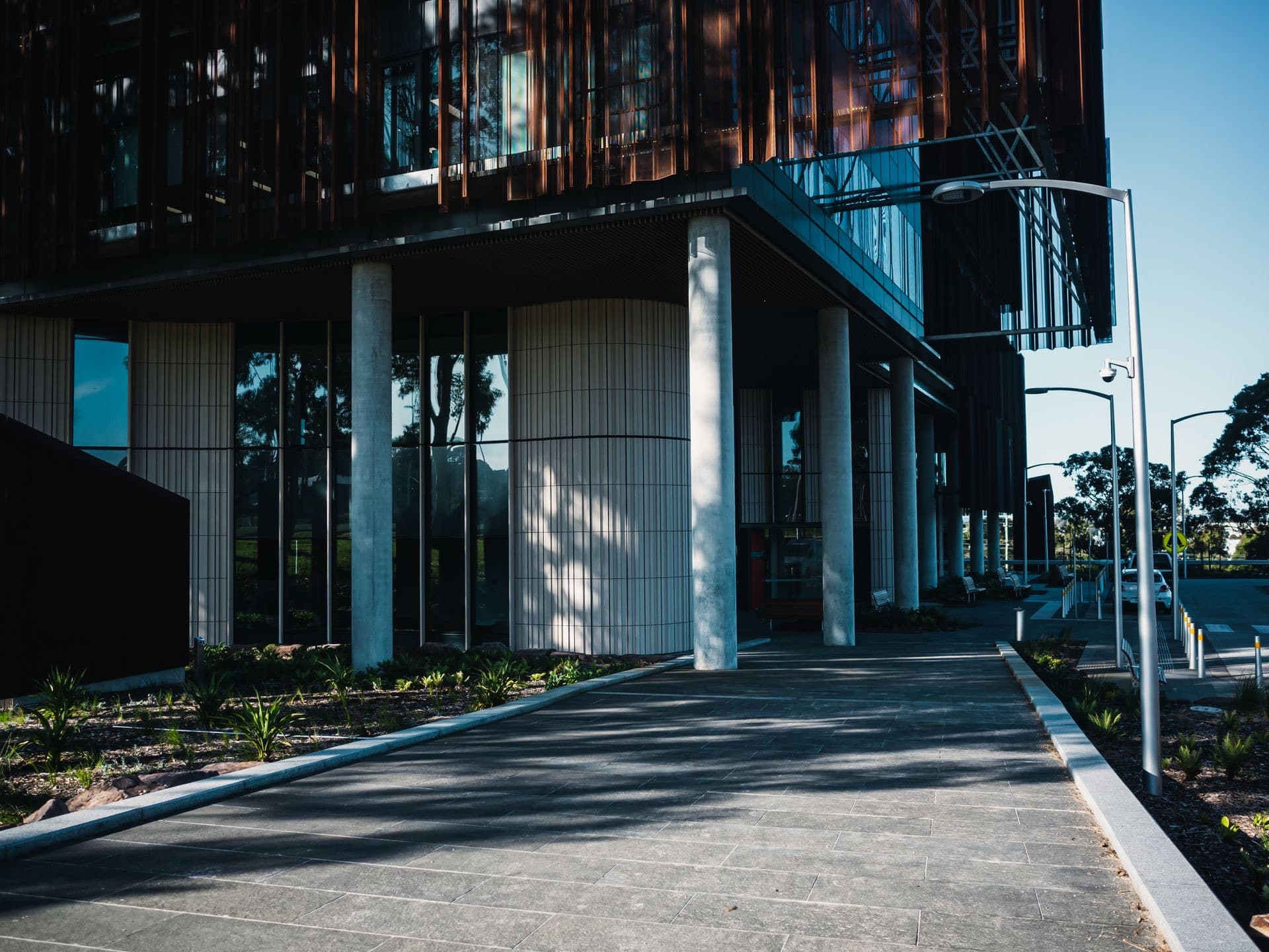 A modern healthcare facility entrance and covered walkway, daylight