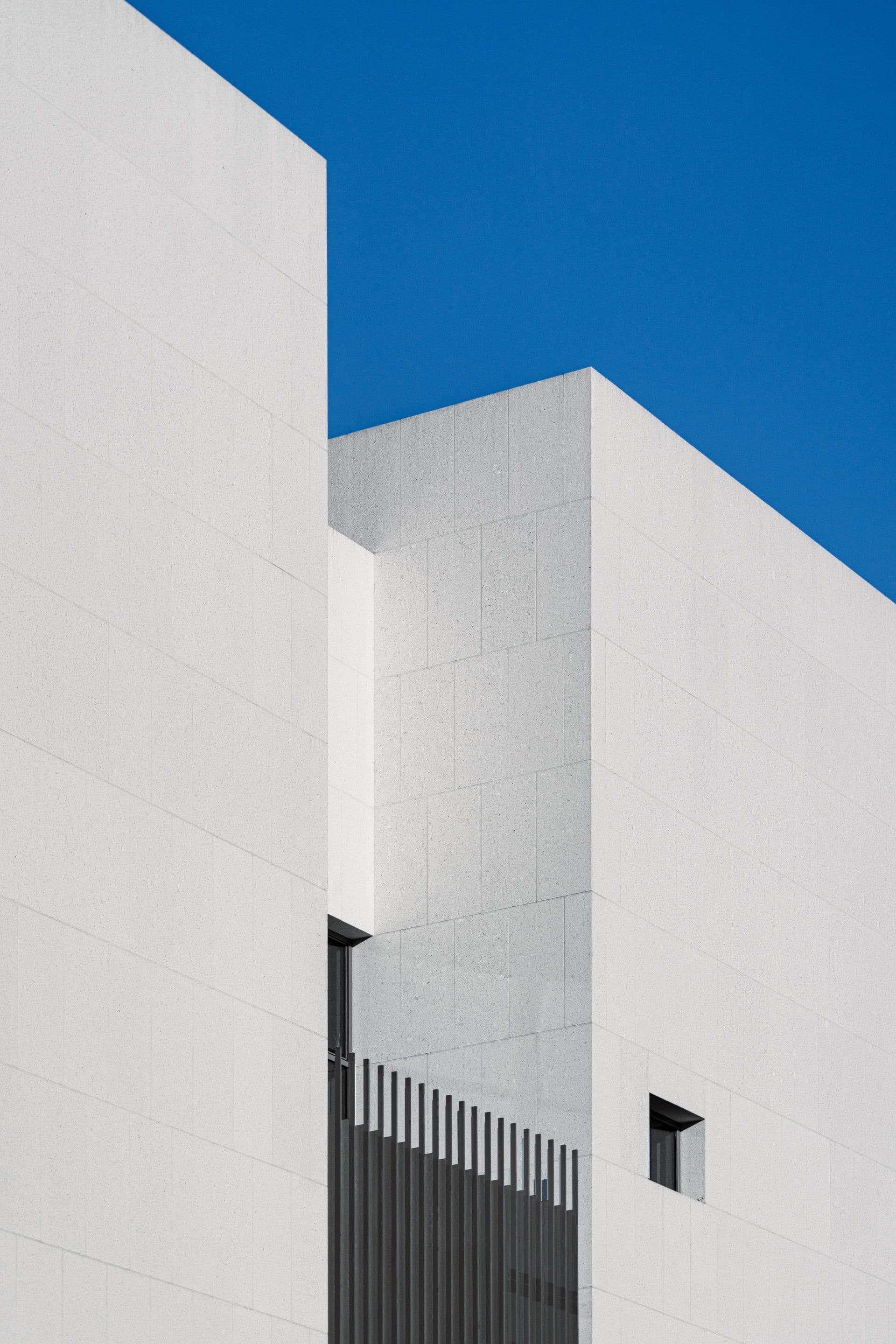 A minimalist, calm building exterior against a clear sky